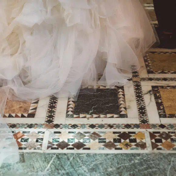 Bride and groom's feet on the mosaic floor of the Fitzrovia Chapel London